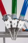 threee dropdispensers mounted on a large corner plate for generating multi colour collisions